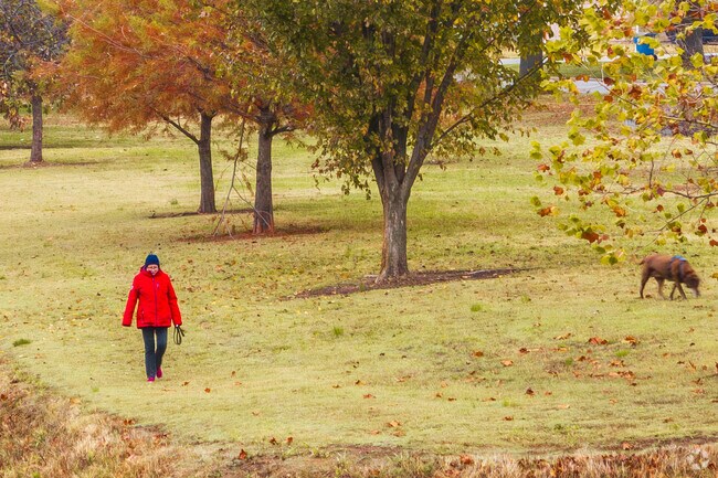 Visitors to Campbell Parkway enjoy the open green space for walking their dogs.
