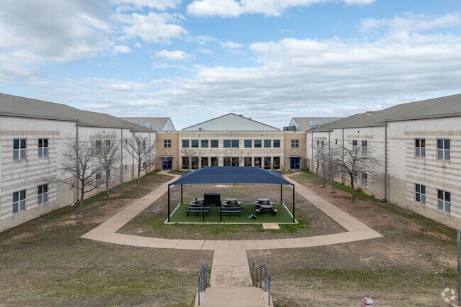 Covered lunch tables can be found in Whitestone Elementary School's courtyard.