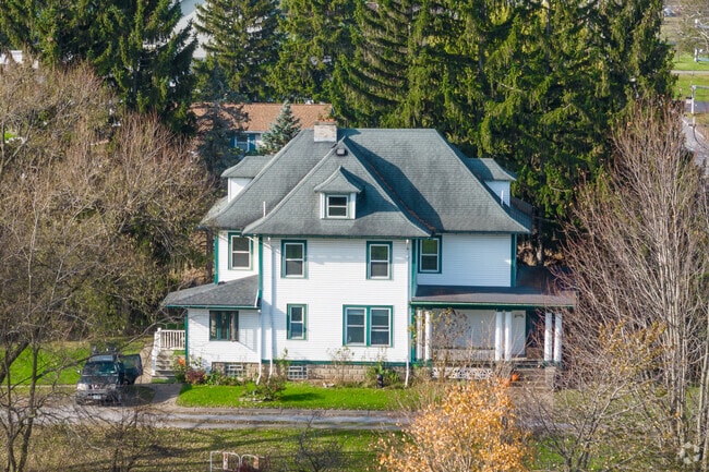 An excellent two-story home in East Amherst is nestled between trees.