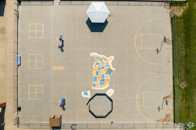 There is a large paved area outside for a variety of activities at Apollo Elementary School.