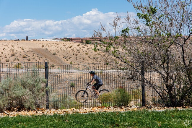 Cyclists enjoy the trails weaving through Black Arroyo Park near Stonebridge Pointe.