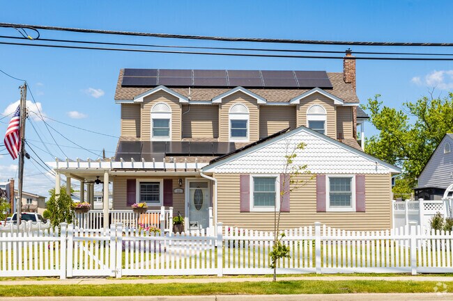 Colonial-style homes with gable roofs and dormers are common across New York neighborhoods.