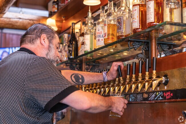 McMenamins Raleigh Hills Pub features a wide selection of house-made craft beers on tap in a cozy setting.