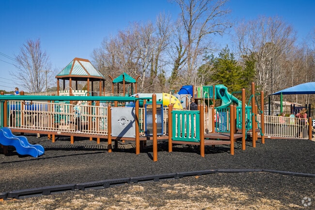 Children from Elon delight in exploring the playground at Beth Schmidt Park.