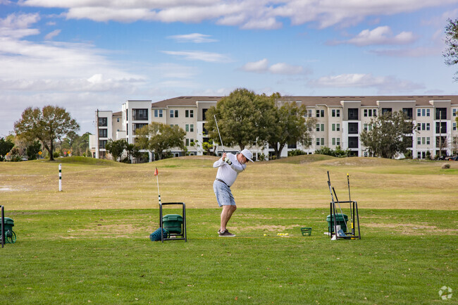 Residents practice their swing on the driving range at Forest Lake Golf Club near Prairie Lake.