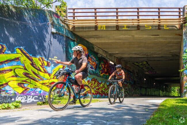 Bike riders pay homage to the beautiful graffiti found along the Tri-Community Greenway near North Main.