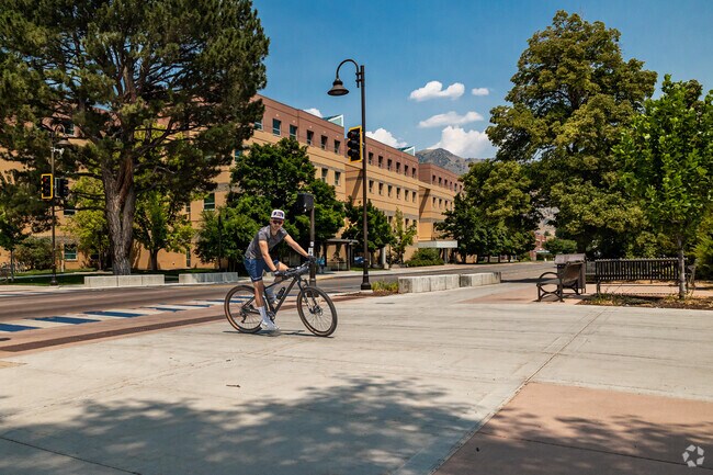 A student bikes on Utah State’s campus in Adams.