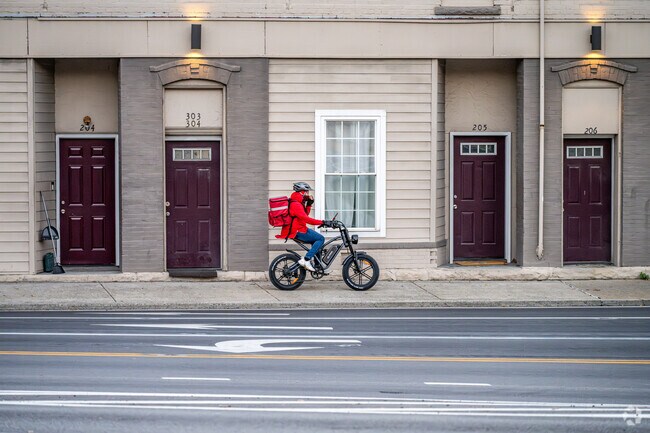 A food delivery person rides their electric bike to make the rounds in Sunnyside.