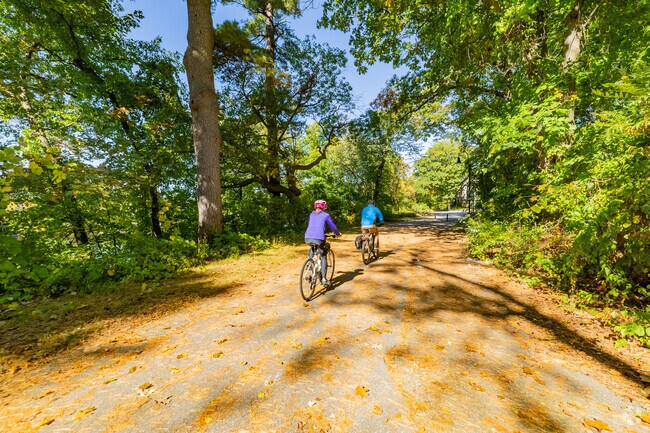Cyclists enjoy paved trails at Riverwalk Park in the Bakersville neighborhood.