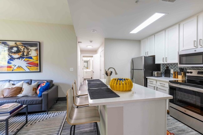 Valentine-Commons-Off-Campus-Apartments-Just-Steps-From-NC-State-University-Platinum-Floor-Plans-Living-Room-to-Kitchen-Open-Floor-Plan-with-Kitchen-Island-Seating