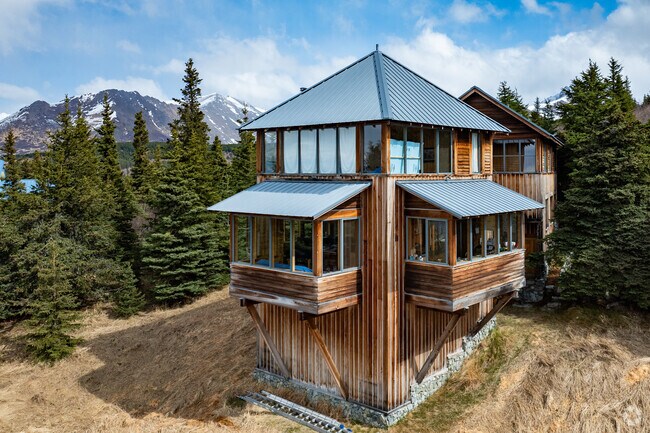 A custom chalet-style home in Hillside East offers views of both the mountains and the city skyline.