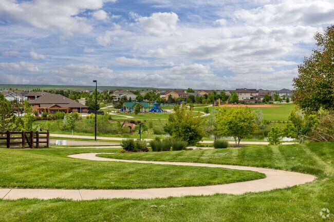 Residents enjoy the curved paved walking paths and green space in the Village at Five Parks.