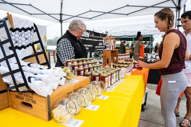 Local vendors sell goods at Stadium's farmers market.