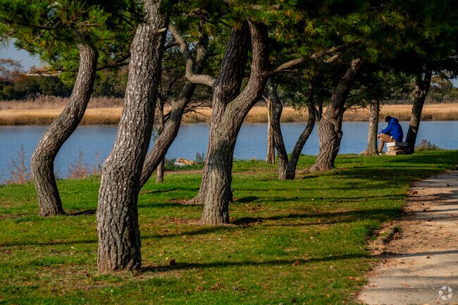 Meditate or exercise at Inwood park which features a baseball field, hockey rink ,and a trail.