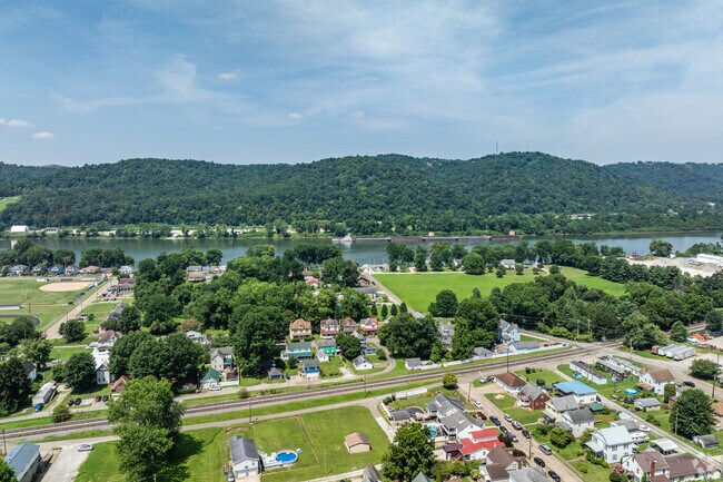 New Martinsville is along the Ohio River in a valley between two hills on either side.