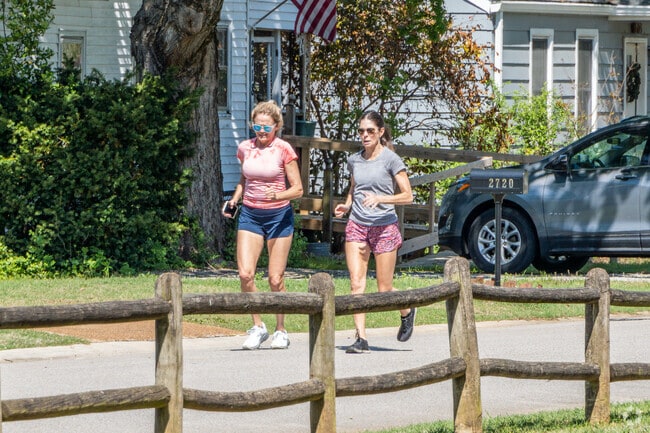 Women jog on the street during a nice day in Mayfair-Piedmont.