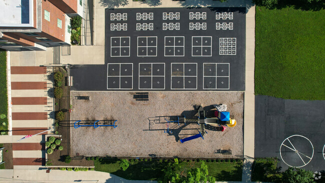 Clinton Elementary School has a large black top for students to play.