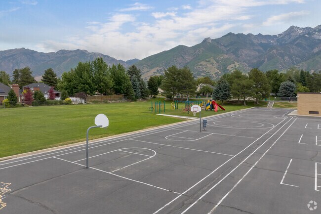 Basketball courts, mature trees and mountain views at Quail Hollow Elementary School.
