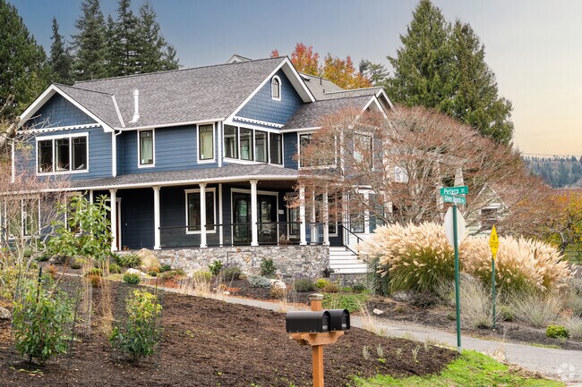 Larger homes in Geneva often feature large wrapping front porches.