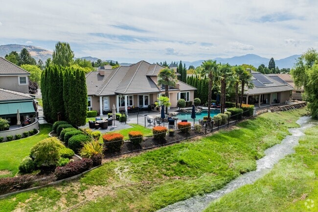 Rogue Valley homes have a troubled appearance with palm trees along their borders.