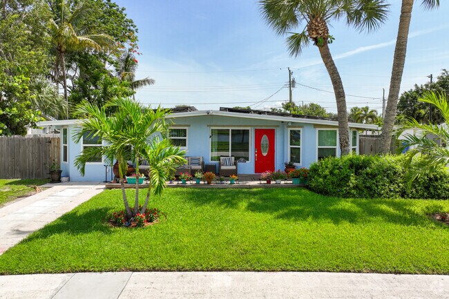 Red door home with well-maintained front garden in Counterpoint Estates neighborhood.