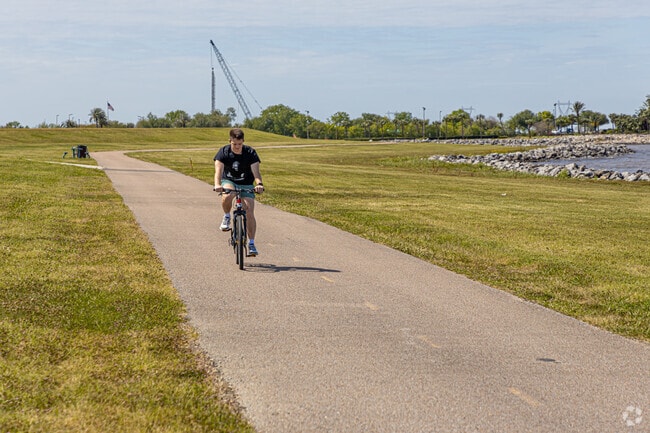 A bicyclist riding along the shore of Lake Pontchartrain near Elmwood Park.