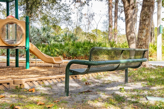 Parents have a bench to watch their kids play at Arbor Green CCD Playground.