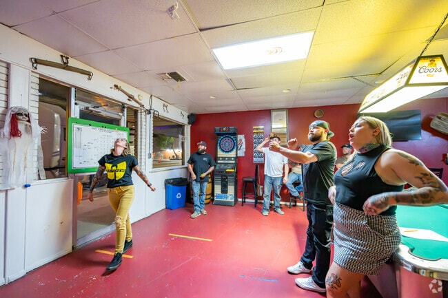 West Bishop locals celebrate the win, and loss of a game of darts at Rusty's Saloon.