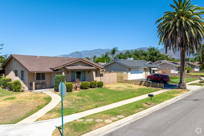 A charming row of ranch-style homes lines a peaceful street in Alta Loma’s scenic neighborhood.