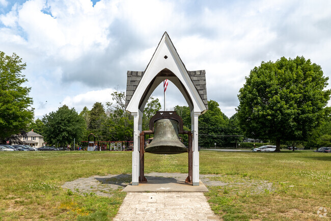 A large school bell sits outside the playground at Howard Elementary School in West Bridgewater.