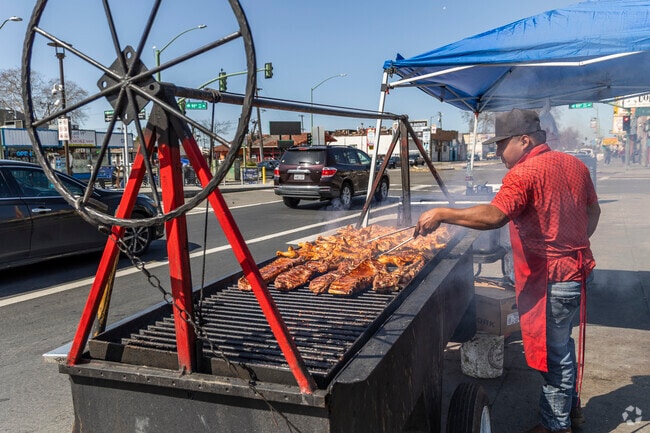 Highland street vendors cook fresh meat on open topped barbecues in the street.