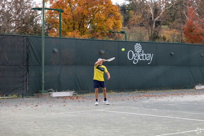Tennis players practice their swing at Oglebay Park near Mozart.