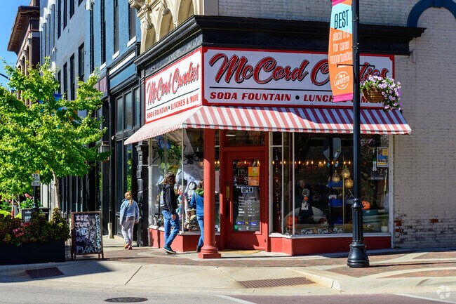 A young family window shops in front of McCord's Candies in downtown Lafayette near Perrin.
