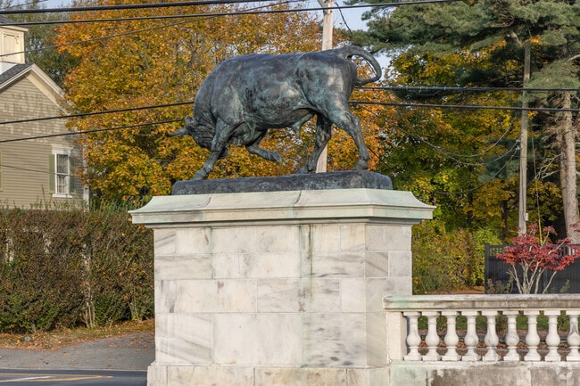 Bronze statues of prize bulls guard the drive to Colt State Park in Bristol Highlands.