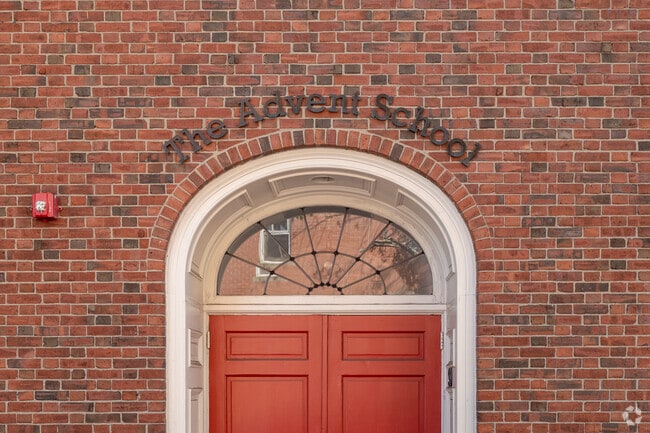 An arched sign over the front enterance of The Advent School in Boston.