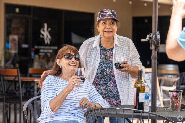 Sipping wine with friends at the street fair. Cheers to good times and great company.