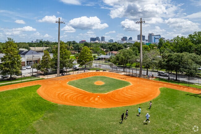 John H Jackson Neighborhood Center baseball field with kids running in Parramore.