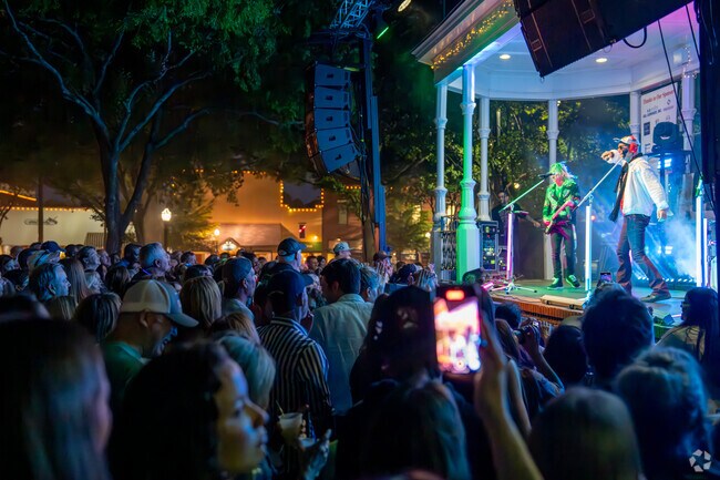 Large crowds form in front of the stage at the Glover Park Concert Series to enjoy the music.