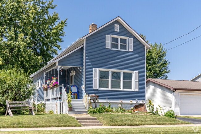 A traditional home in Sacred Heart shows tidy updates and a sunny front lawn.