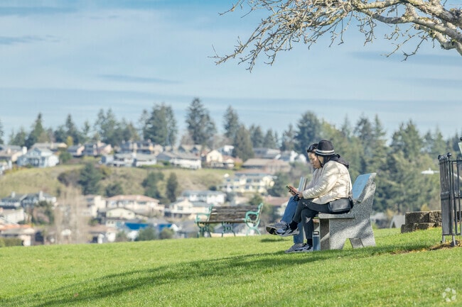 Friends take a seat at Pioneer Orchard Park in Palisade Village Washington.