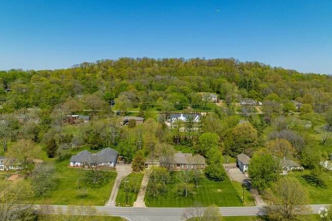 Otter Creek homes sit on the foot of large rolling green hills.