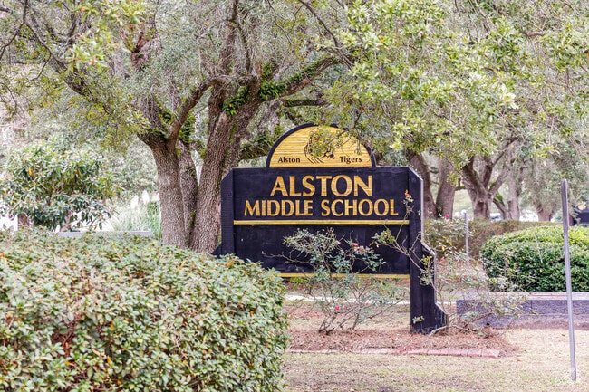 Alston Middle School welcomes students with a sign at the front entrance.