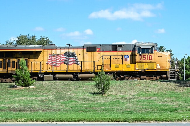 A Union Pacific locomotive proudly displays the American flag as it passes through Abilene.