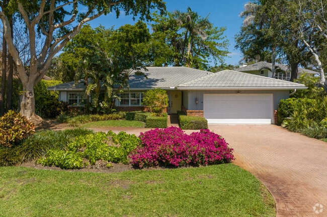 This beautiful ranch home sits underneath the shades in Park Shore, FL.