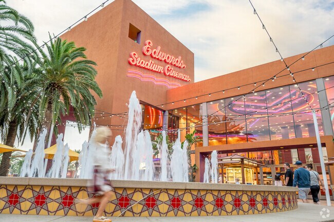 A young resident runs around the fountain outside the Tustin Ranch cinema.