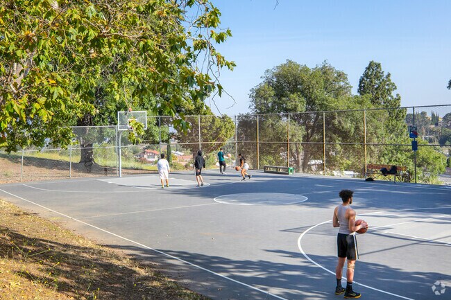 Shoot hoops at the full basketball court in Porter Ridge Park, Porter Ranch.