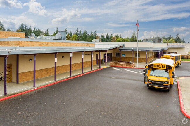 Busses wait for students in front of Walter L Kraxberger Middle School.