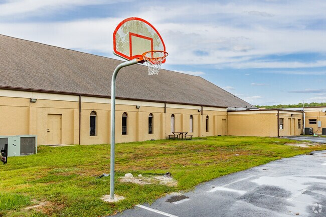 Kids have sports courts for outdoor exercise at Learning Lodge Academy in Port Richey.