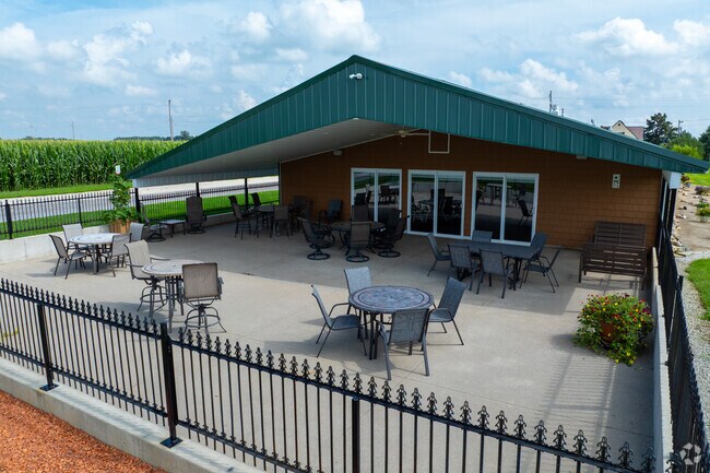 In Coldwater, Evergreen Farm has an Outdoor patio with tables, chairs, and cornfield views.