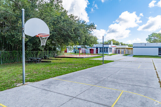 Kids enjoy outdoor play on the sports courts at Cypress Wood Elementary.